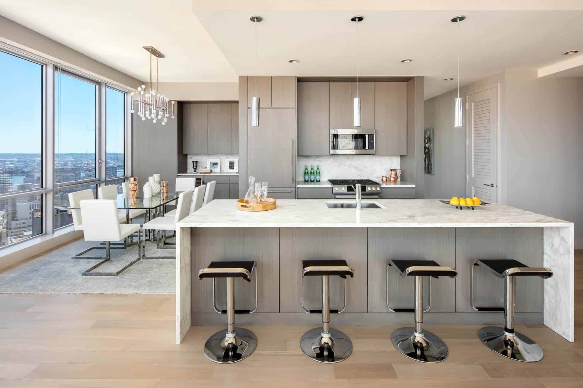 Open-plan kitchen and dining area at TheLume showing family-sized layout with natural light and sea views