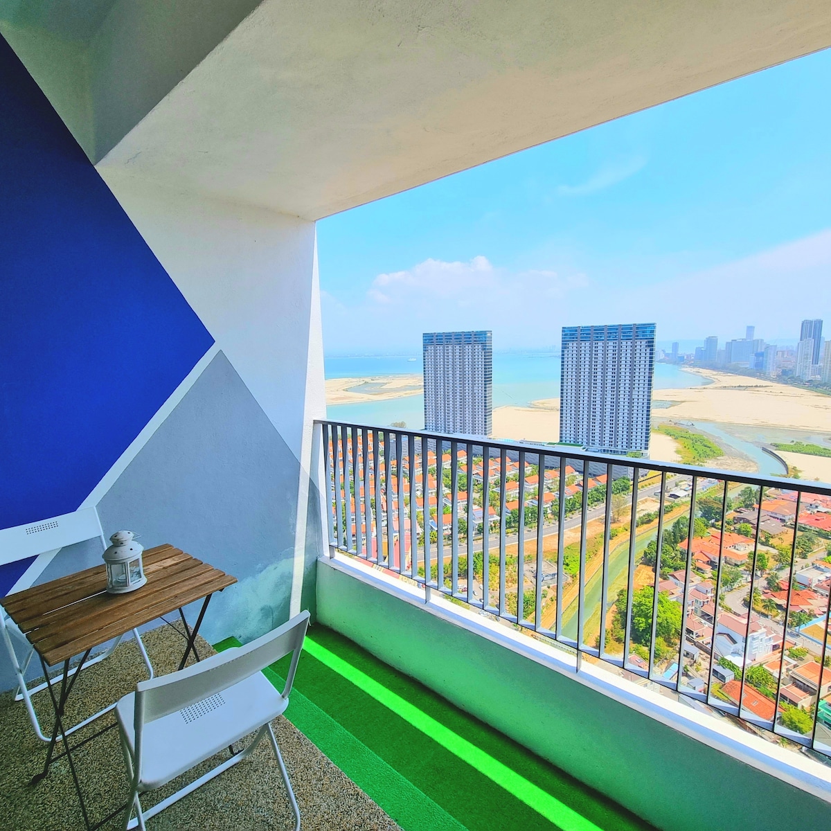Morning sunrise view from TheLume balcony overlooking Andaman Sea contrasting with urban Gurney Drive lifestyle