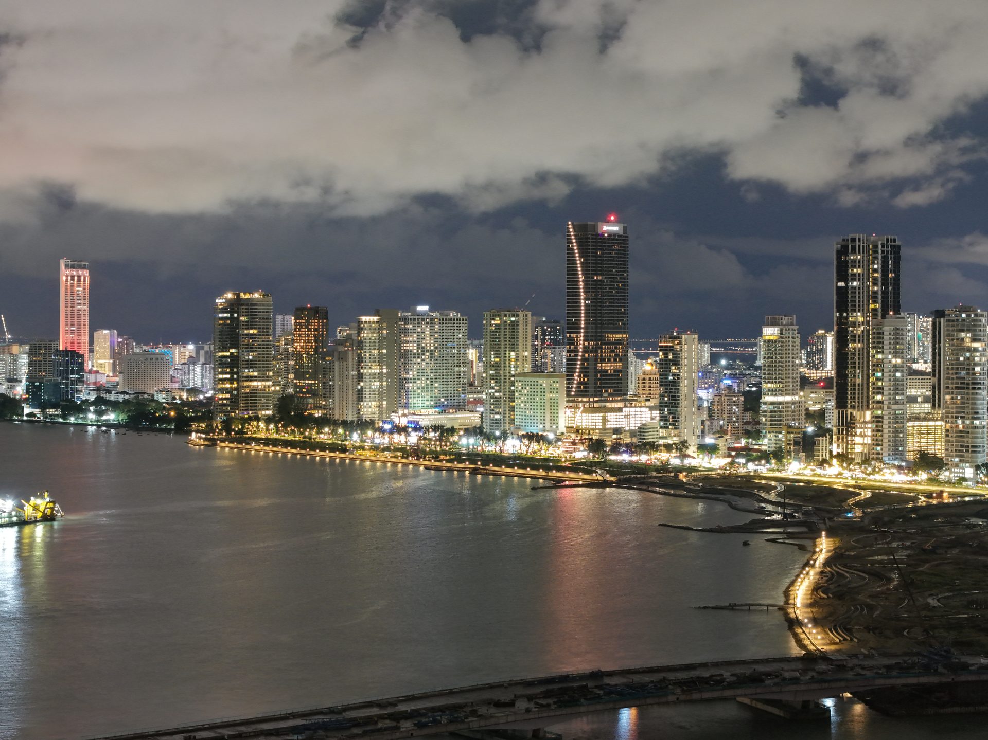 Gurney Drive seafront promenade at evening with luxury condominiums and hawker centre Penang