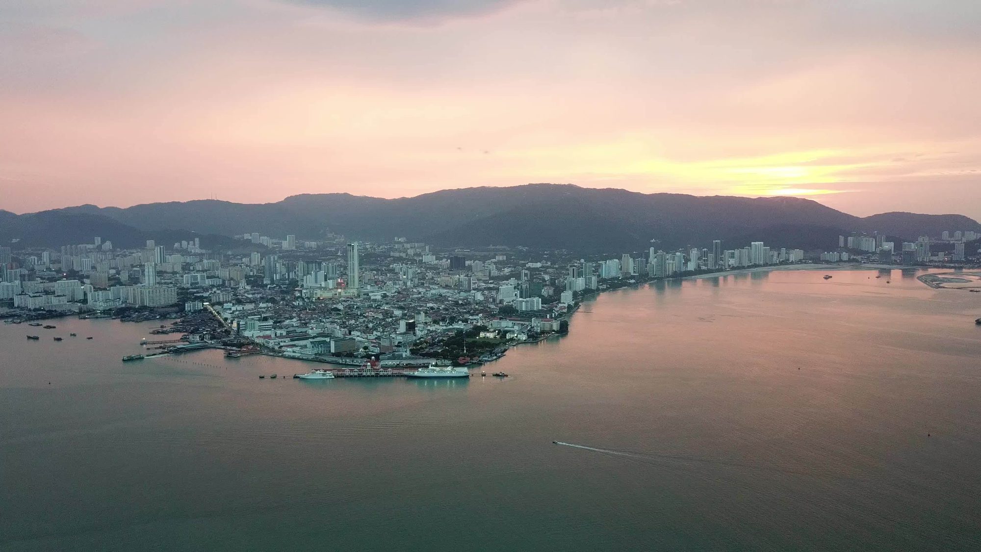 Penang island skyline at sunset showcasing property investment growth corridor along Tanjung Tokong coastline